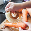 Eco Basics Vegetable Brush in use scrubbing carrots